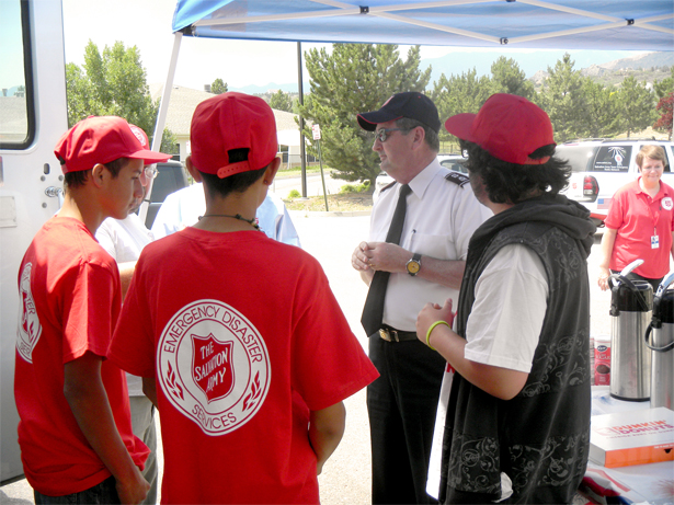 Commissioner James Knaggs (Territorial Commander, USA Western Territory – wearing blue cap) speaks to volunteers helping The Salvation Army response in Waldo Canyon, Colorado (Photo by Claire Dunmore).