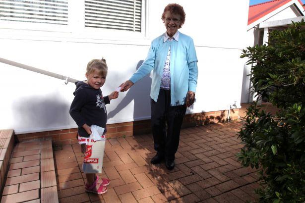 Four-year-old volunteer collector Annie Martin hands a receipt to a generous supporter.